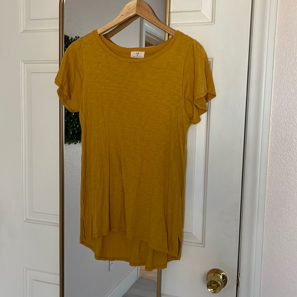 Small Anthropologie mustard yellow blouse with ruffle sleeves.